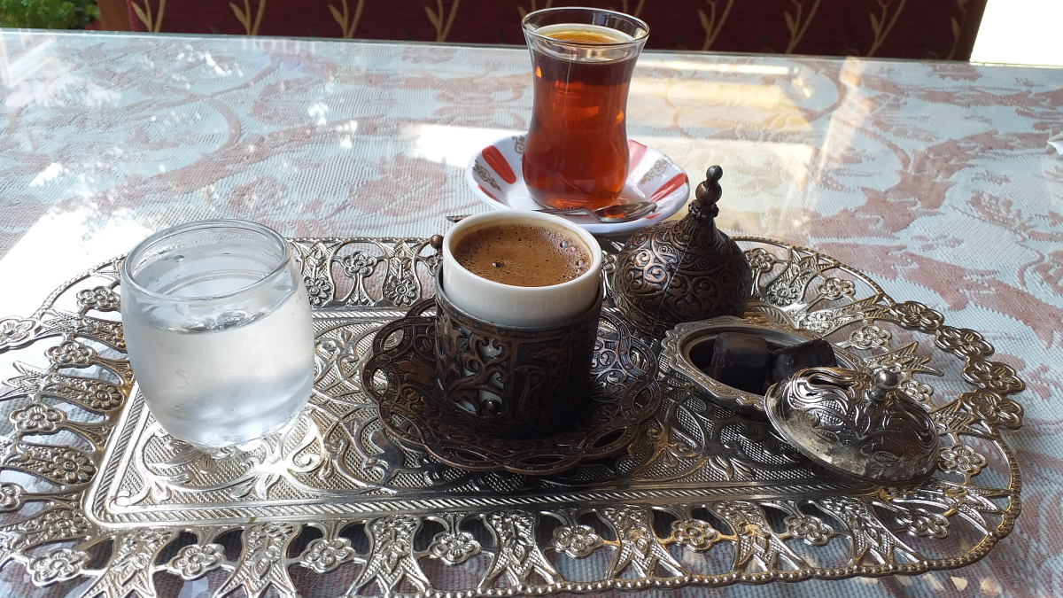 Turkish coffee being poured into a cup on an ornate silver tray in Istanbul